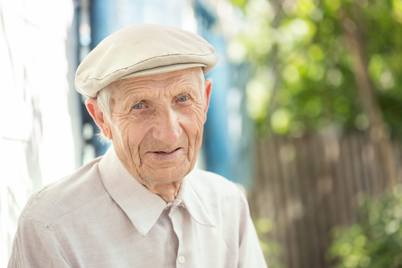 An older man wearing a cap, looking at the camera.